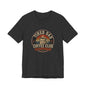 Close-up of the vintage 'Caffeine & Chaos' badge graphic on the Tired Dad Coffee Club T-Shirt
