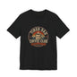 Tired Dad Coffee Club T-Shirt front view in black, featuring a vintage badge design with a steaming coffee mug and 'Caffeine & Chaos' motto